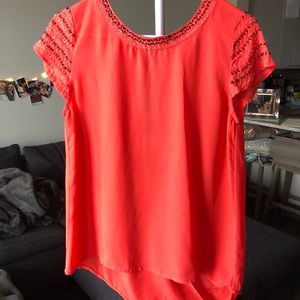 Red-orange open-back top with beaded detail